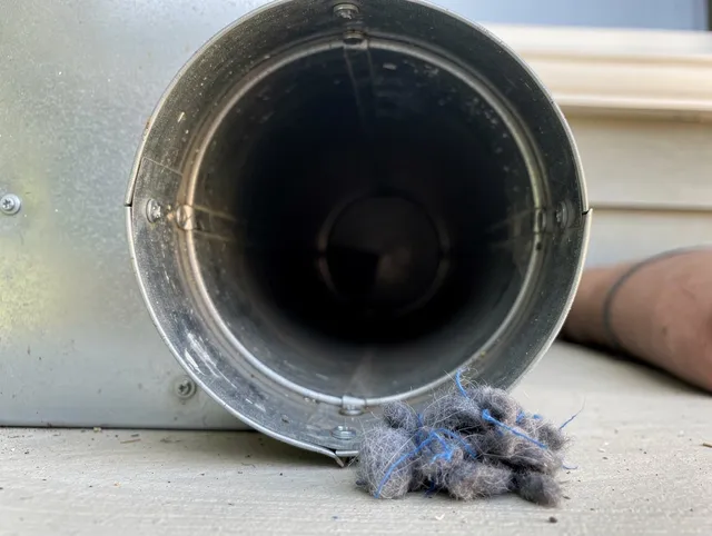 Westborough Dryer Vent Cleaning technician using specialized equipment to clear severe dryer vent blockage in Westborough